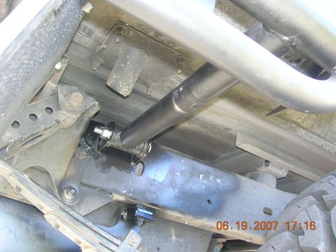 1996 Ford Bronco - Close-up view of the undercarriage of a vehicle, revealing suspension parts and a metal bar with a date stamp.