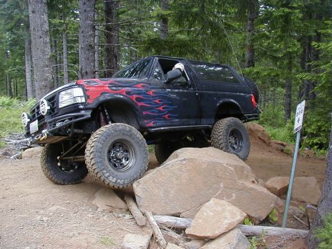 1994 Ford Explorer - Modified SUV navigating a challenging rocky off-road course.