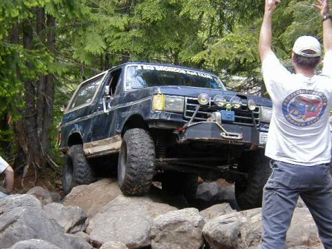 1994 Ford Explorer - A Ford Bronco navigates a rocky trail during an off-road event.