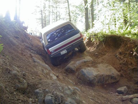 1994 Ford Explorer - This 1994 Ford Bronco is shown tackling a challenging off-road trail with steep inclines and large rocks.