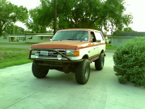 1982 Ford Bronco - This lifted Ford Bronco has a two-tone paint job and an aftermarket front bumper with auxiliary lights.