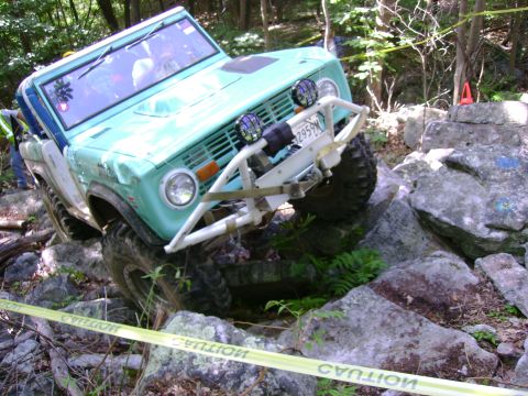 1969 Ford Bronco - This 1969 Ford Bronco is tackling a challenging off-road course with large rocks.