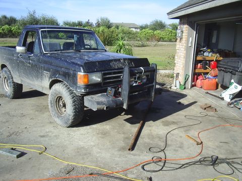 Black 1982 Ford Bronco with brush guard parked in driveway