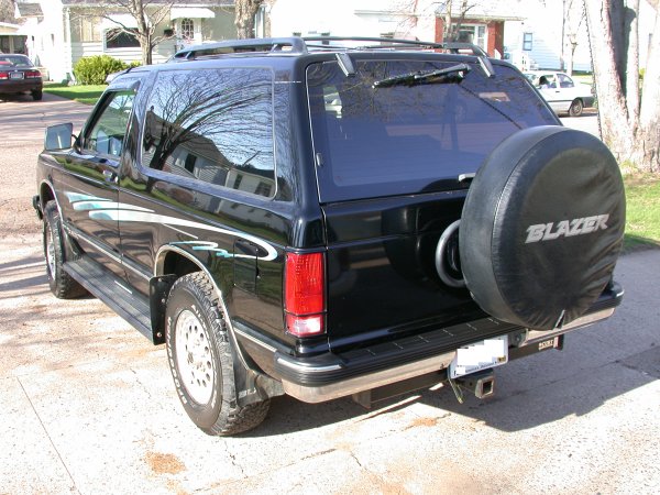 Black SUV with spare tire labeled BLAZER