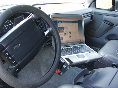 1996 Ford Bronco - Interior view of a Ford truck's dashboard, showing a laptop mount and a Dell laptop.