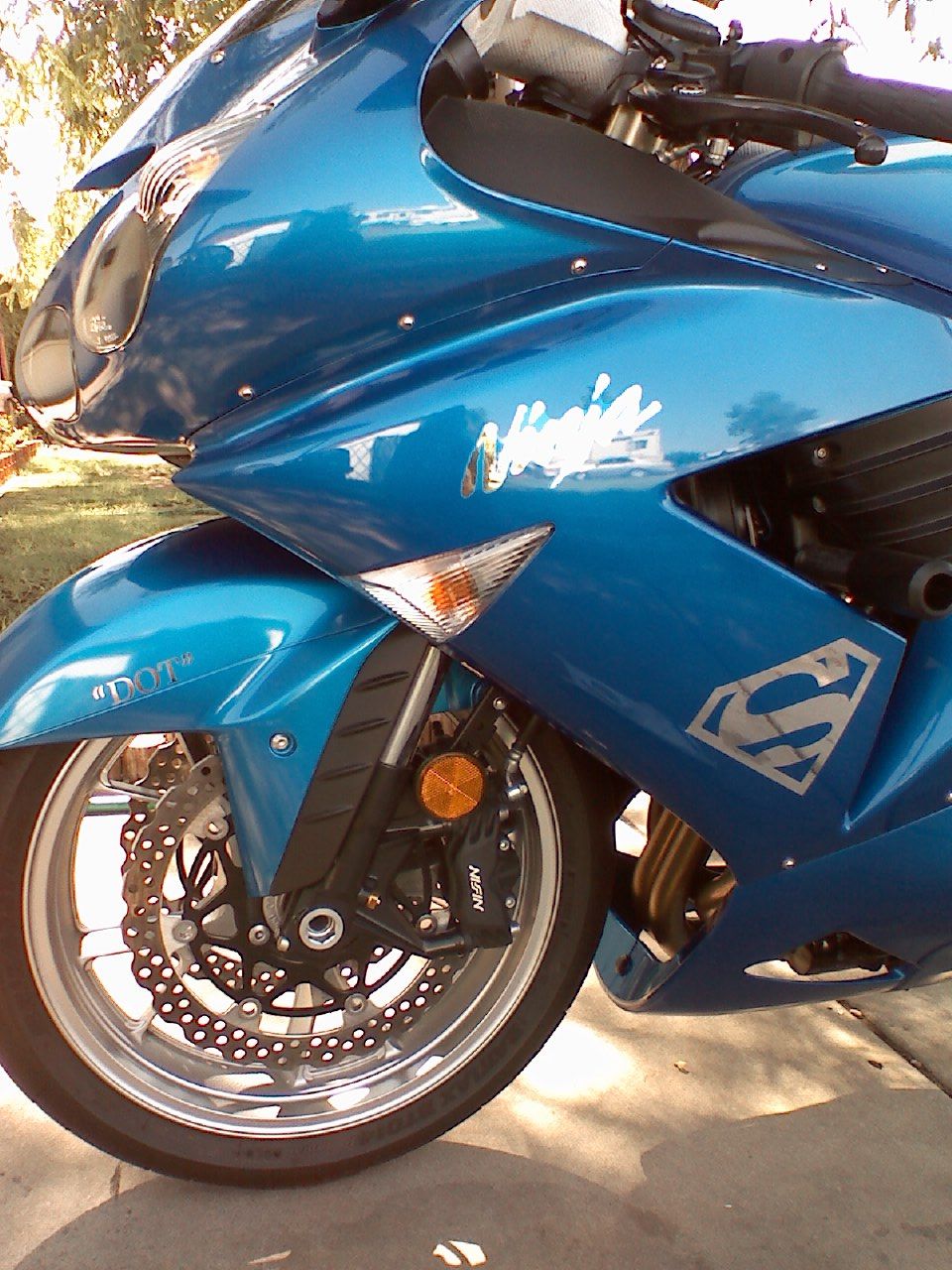 Blue motorcycle with Superman logo and Ninja decal