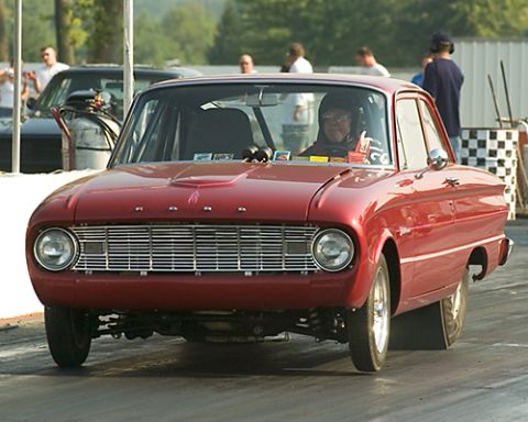 1960 Ford Falcon - Red 1960 Ford Falcon drag car on the track, driver in helmet.