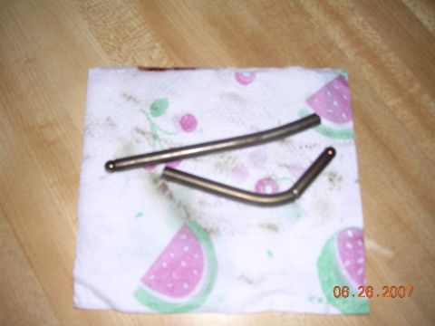 1978 Ford Bronco - Two metal valve lifters are placed on a paper towel with a watermelon print.