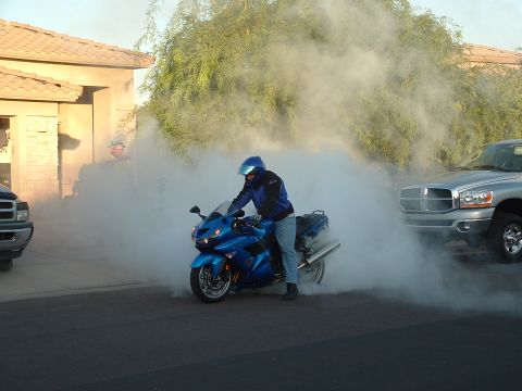 2007 Kawasaki Ninja - Motorcycle performing a burnout, creating a large cloud of smoke.