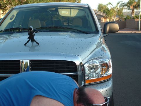 2007 Kawasaki Ninja - A silver pickup truck is shown from the front, with a person bending over in front of the grille.