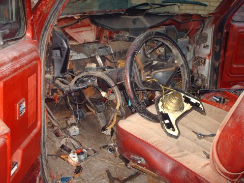 1982 Ford Bronco - The interior of this vehicle is in a state of disrepair, with exposed wiring and a disassembled dashboard.
