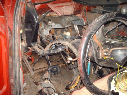 1982 Ford Bronco - The interior of this vehicle shows a complex network of exposed wiring and pedals, suggesting a need for repair or modification.