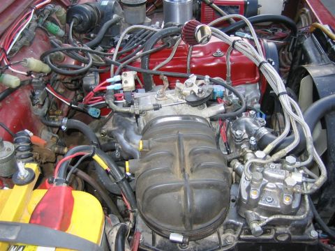1987 Suzuki Samurai - Close-up view of a vehicle's engine bay, showing various components and wiring.