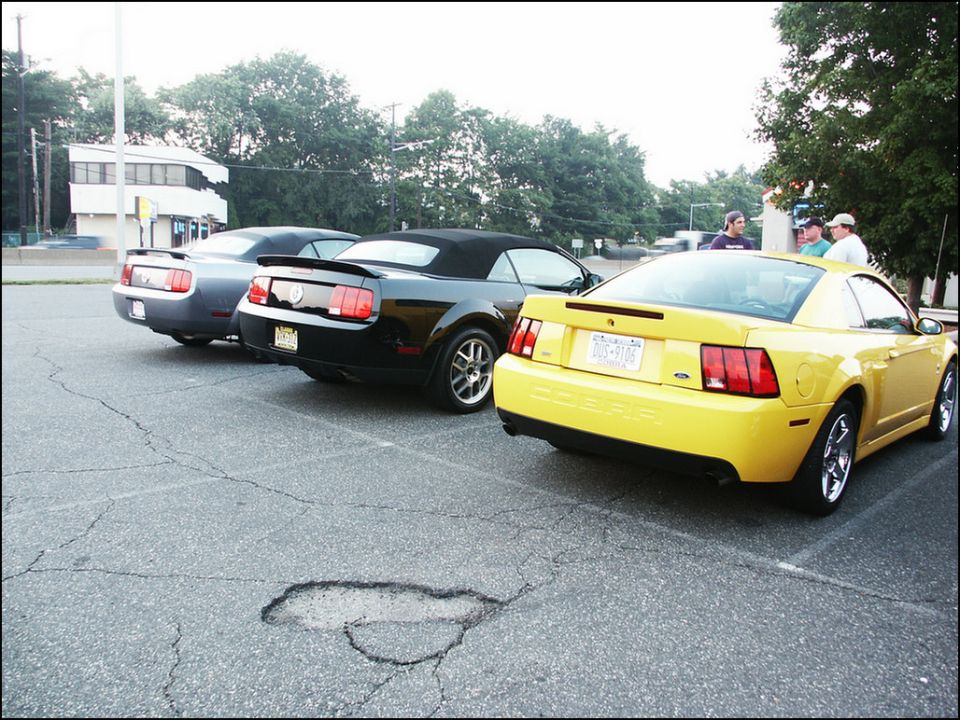 Yellow 2001 Ford Mustang coupe parked in a lot