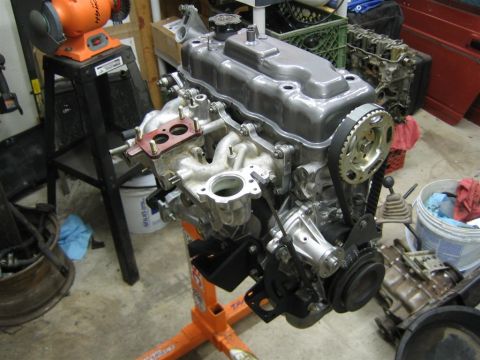 1987 Suzuki Samurai - Engine assembly on a stand, showing the timing belt and various components.