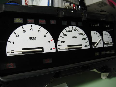 1992 Ford Taurus - A set of aftermarket white-faced gauges for a car's dashboard, displaying RPM, MPH, fuel, and water temperature.