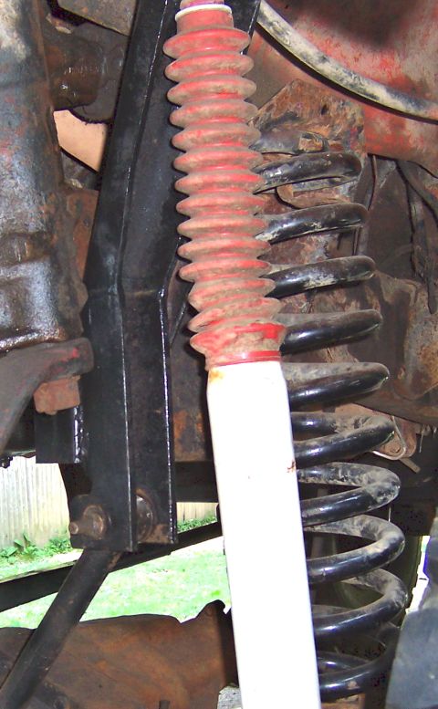 1978 Ford Bronco - This image shows the suspension system of a vehicle, focusing on the shock absorber and coil spring.
