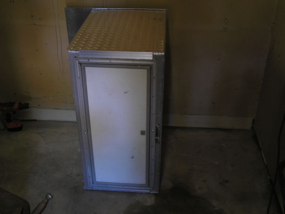 Aluminum storage cabinet with diamond plate top and white door