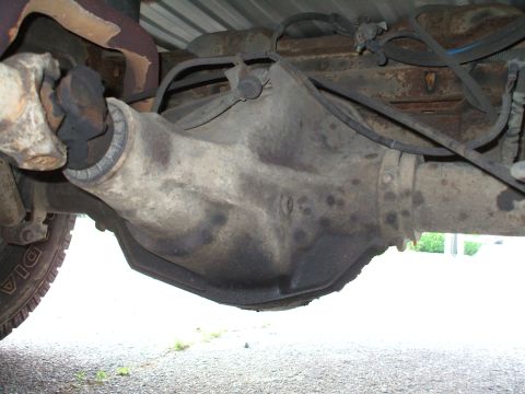 1994 Ford Bronco - Underside view of a vehicle's rear differential and driveshaft assembly.