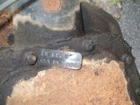 1994 Ford Bronco - Differential housing with a stamped metal data plate, likely a part number or identification tag.