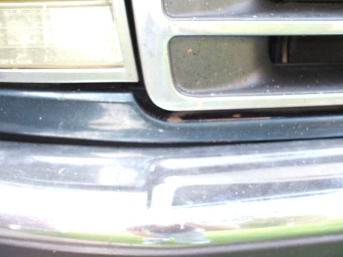 1994 Ford Bronco - Close-up of the front grille and headlight assembly on a 1994 Ford Bronco.