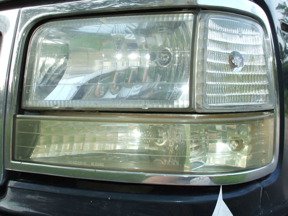 Close-up of a Ford truck composite headlight with amber corner and lower turn lamp