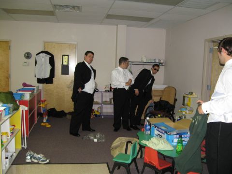 1988 Ford Bronco - Men dressed in formal attire gather in a room before an event.