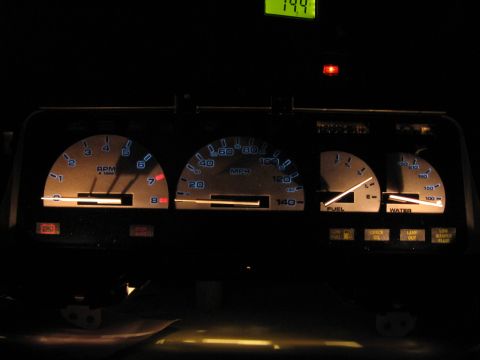 1992 Ford Taurus - Illuminated dashboard gauges display RPM, speed, fuel, and water levels in a vehicle's interior.