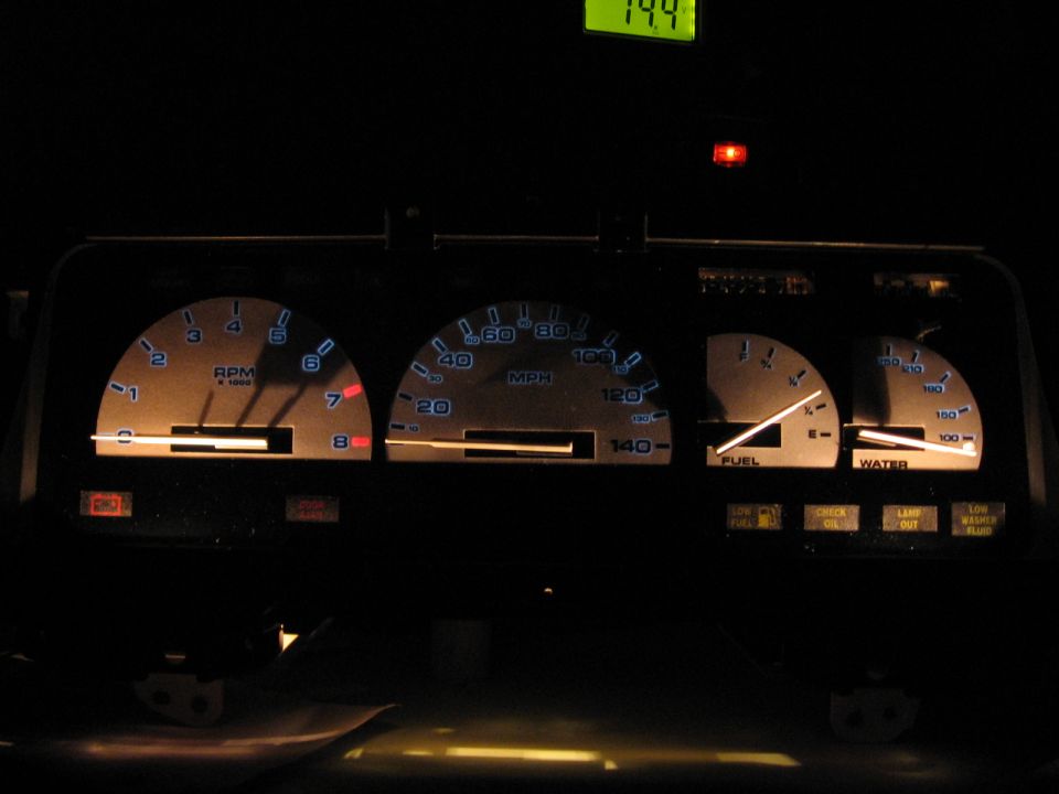 Dashboard gauges with illuminated tachometer, speedometer, fuel, and water gauges