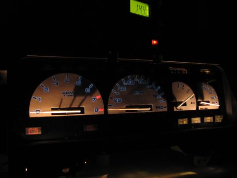 1992 Ford Taurus - Illuminated dashboard gauges including tachometer, speedometer, fuel, and water levels. A digital display shows 14.4.