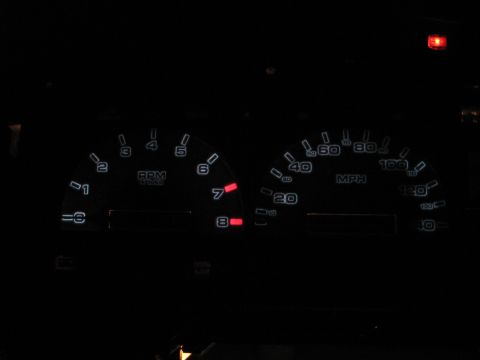 1992 Ford Taurus - Illuminated car dashboard gauges show RPM and MPH readings in the dark.