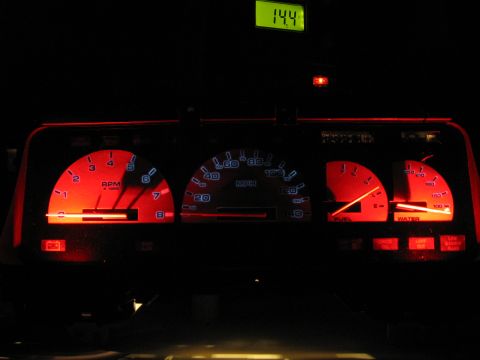 1992 Ford Taurus - The illuminated dashboard features a speedometer, tachometer, and other gauges, with a digital readout at the top.