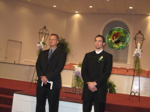 1988 Ford Bronco - Two men in formal attire stand on a raised platform in a church setting, awaiting an event.