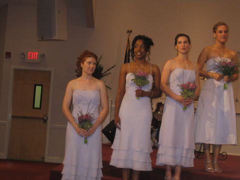 1988 Ford Bronco - Bridesmaids stand on a stage holding flowers, with an exit sign visible in the background.