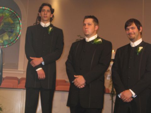 1988 Ford Bronco - Three men in formal wear stand in a room that appears to be a wedding venue.