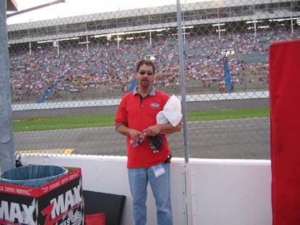 1971 Ford Ranchero - A man stands in front of a crowded grandstand at a race track.