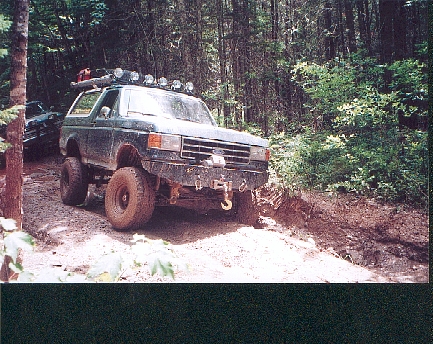 1989 Ford Bronco - This modified SUV navigates a challenging off-road course, with another vehicle visible in the background.
