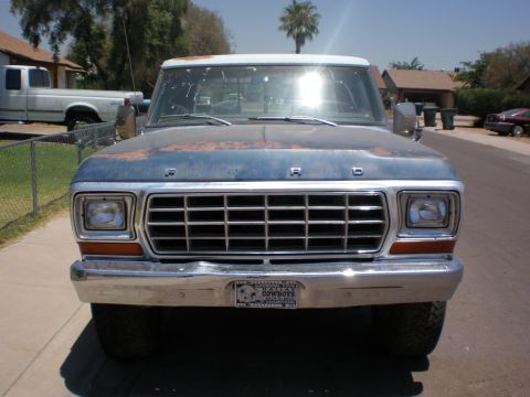 1978 Ford F-250 - Front view of a 1978 Ford F-250 pickup truck, showing its grille and headlights. Another truck is visible in the background.