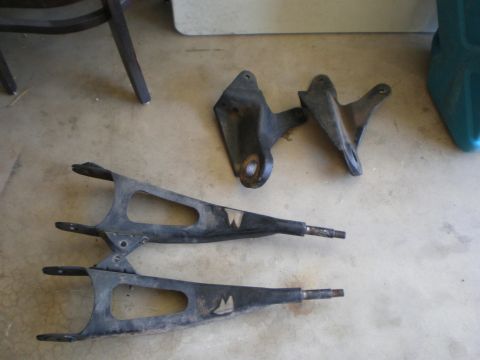1978 Ford F-250 - Front suspension control arms and mounting brackets are shown, with a "W" emblem visible on each arm.