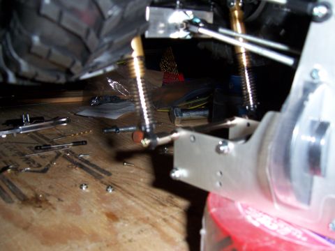 1996 Ford Bronco - This image shows a collection of vehicle suspension components and tools laid out on a wooden workbench.