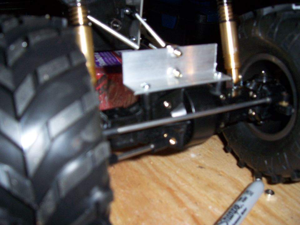 Close-up of RC car suspension with large tire and aluminum bracket