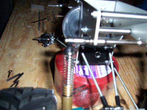 1996 Ford Bronco - A close-up view of a mechanical component, possibly from a model or hobby project, resting on a wooden surface.