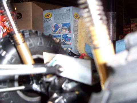 1996 Ford Bronco - A close-up view of vehicle suspension parts, with a box of seatcovers visible in the background.