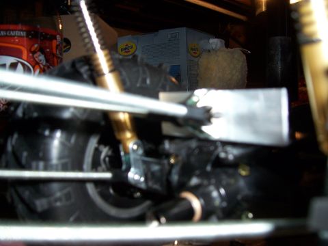 1996 Ford Bronco - Undercarriage view of a vehicle's suspension and wheel assembly, with visible shock absorber and tire tread.