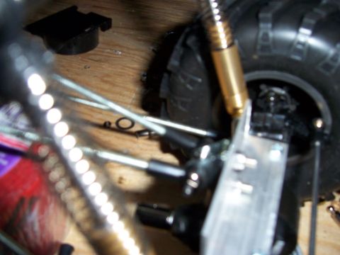 1996 Ford Bronco - Detail shot of the suspension and tire assembly on a remote-controlled vehicle, the SuperMotors logo at the bottom.