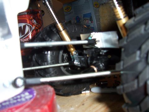 1996 Ford Bronco - Detail shot of RC car suspension and tire, with a root beer can visible.
