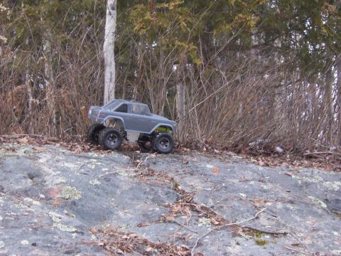1996 Ford Bronco - This remote control toy truck is positioned on a rocky surface with trees in the background.