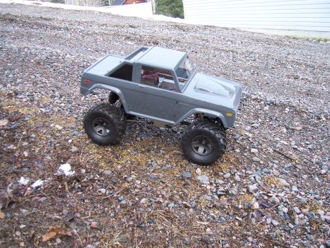 1996 Ford Bronco - A remote-controlled toy Bronco sits on a rocky surface, appearing to be a scaled-down replica.