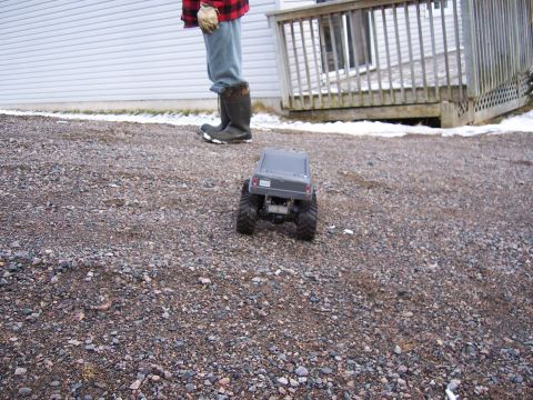 1996 Ford Bronco - A person stands near a remote control truck on a gravel driveway with patches of snow.
