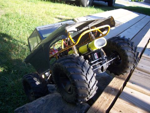 1996 Ford Bronco - This remote control monster truck is shown from the rear on a wooden ramp.